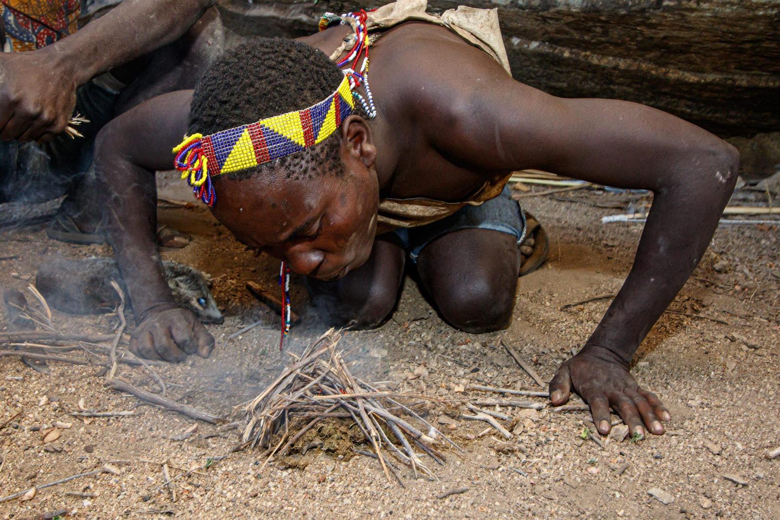A Hadzabe man making fire with sticks