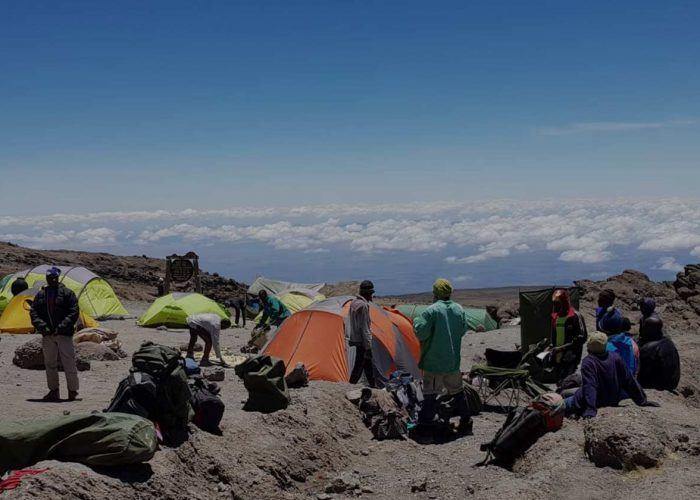 Mountain crew and trekkers resting at camp