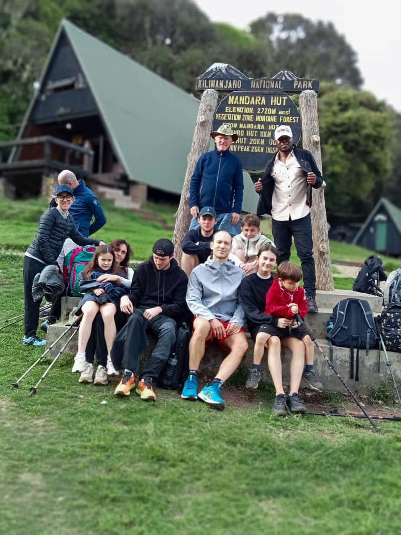 A group of climbers celebrating at Marangu Gate