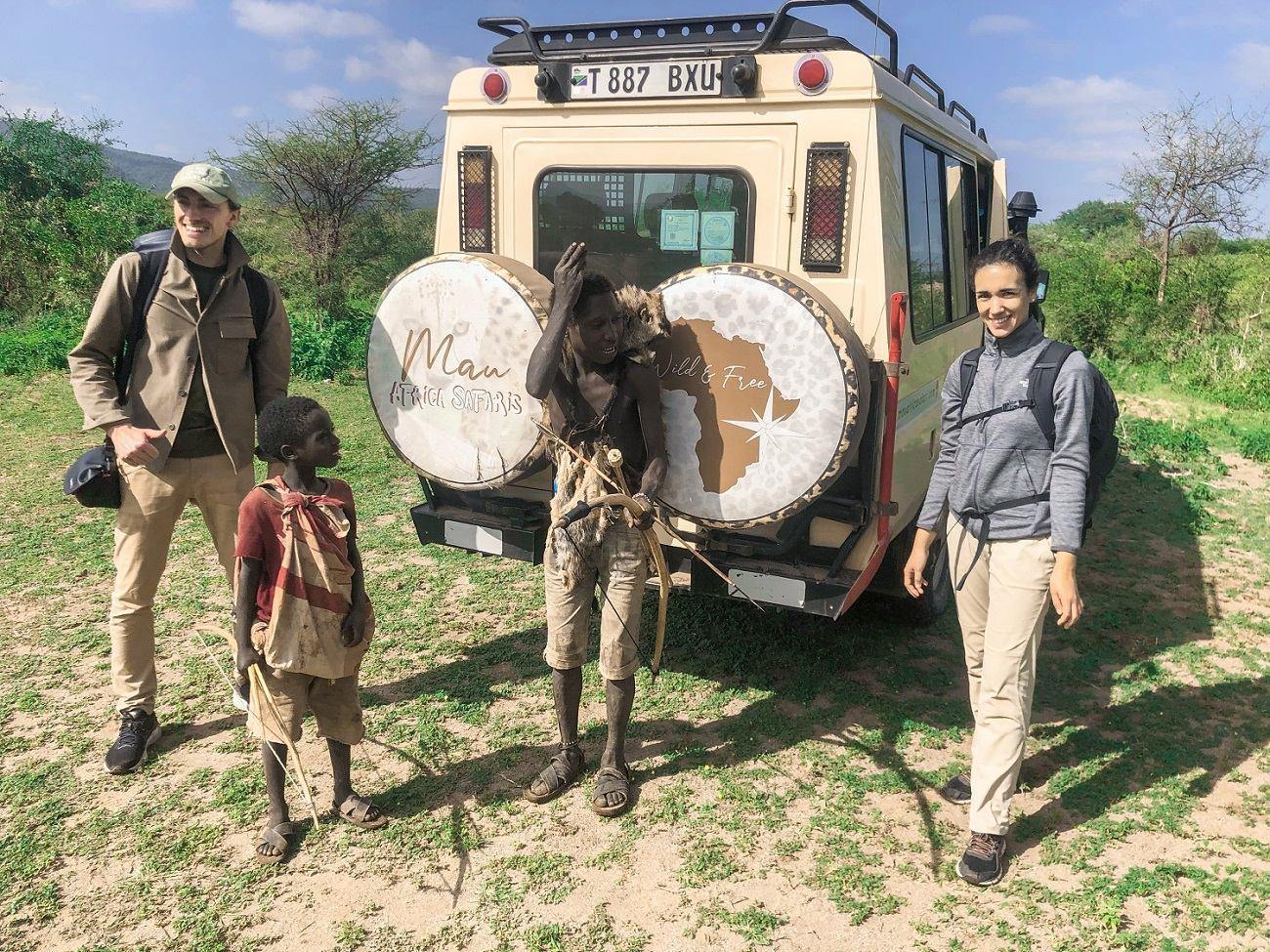 Mau Africa guests beside their safari vehicle