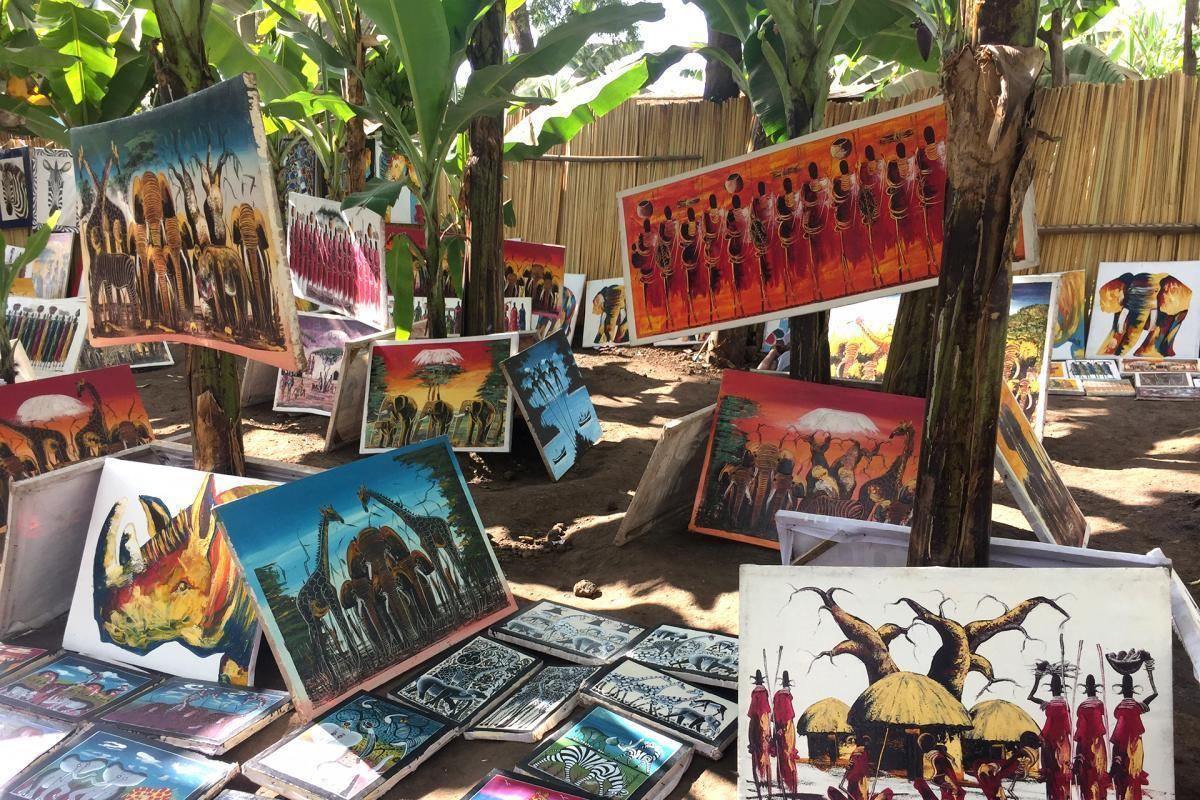 Colourful Tingatinga paintings at a market stall