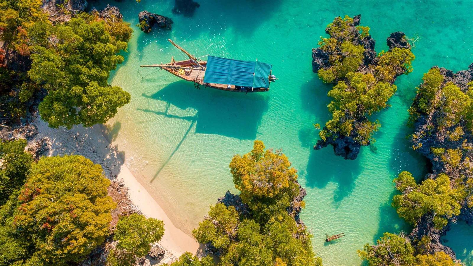 Aerial view of a dhow over turquoise Zanzibar water